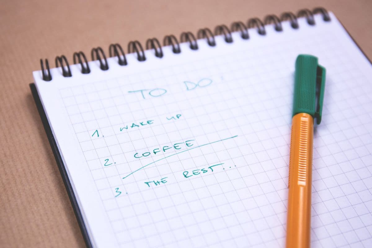 A checklist and coffee on a desk